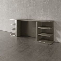 an empty room with concrete walls and shelves