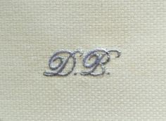 the letters d and g are embroidered onto fabric