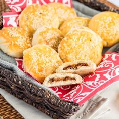 a basket filled with pastries sitting on top of a red and white table cloth