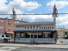 an old movie theater sits on the corner of a street in front of some buildings