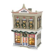 a christmas store with lights and wreaths on the front window is shown in this figurine