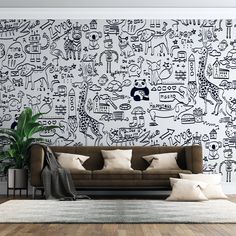 a living room with a couch, rug and wallpaper that has drawings on it