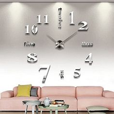 a living room with a pink couch and large clock on the wall in it's center