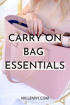 a woman holding a pink purse with the words carry on bag essentials