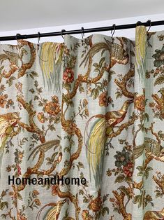 a curtain with a bird and flower pattern on it