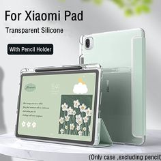 the back and side view of an ipad case with flowers on it, sitting on a table