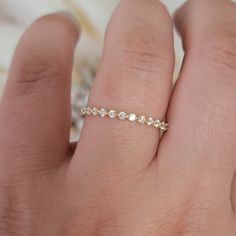 a woman's hand with a diamond ring on it