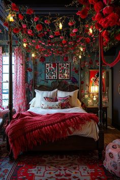 a bedroom decorated in red and green with flowers hanging from the ceiling above the bed