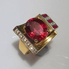 Here we have a superb late Art Deco circa 1940 vivid red rubellite tourmaline, ruby and diamond ring crafted in 14K yellow gold. Rings such as this custom made one of a kind ring from this period are extremely rare to see. True to the late part of the Deco era this ring is geometric, sculptural, chunky, luxurious and eye catching! The colors are divine vivid red, yellow gold, white. In total this ring weighs 11.69 grams. It is a size 5 1/2 US. Please enquire about sizing. The sculptural gem set Ruby Diamond Ring, Red Tourmaline, Art Deco Gold, Rubellite Tourmaline, Ring Ruby, Ruby Diamond Rings, Art Deco Engagement, Gold Art Deco, Ring Crafts