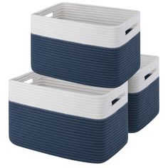 two blue and white storage baskets sitting next to each other