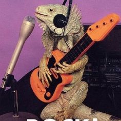 an iguana lizard with headphones and a guitar in front of a microphone