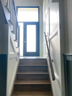 an open door leading up to a set of stairs with wooden steps on each side