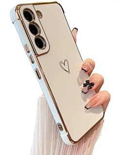 a woman's hand holding up a phone case with hearts on the front and sides