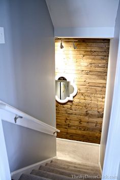 a bathroom with a toilet, sink and mirror