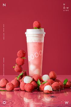 a pink drink with strawberries on the table