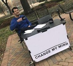 a man sitting at a table with a sign on it that says,'best gaming movie ever '