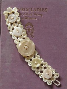 a book with buttons and chains on it