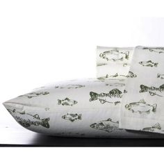 two pillows with fish on them sitting next to each other