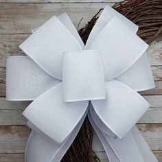 a close up of a white bow on a wreath