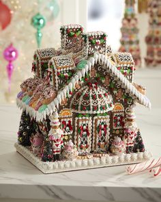 an elaborate gingerbread house with candy canes on the table