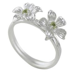 Two winter blooms with green hearts burst open at the top of this cocktail ring from Thailand featuring an elegantly simple design. Sarote Lochotinunt presents this ring which is crafted from sterling silver and fitted with petite stones of peridot. Formal Green Flower-shaped Ring, Elegant Green Flower Ring In Sterling Silver, Elegant Green Sterling Silver Flower Ring, Sterling Silver Wedding Rings For Spring, Green Open Flower Ring For Promise, Green Flower Rings For May Birthstone, Green Flower-shaped Ring For May Birthstone, Green Flower-shaped May Birthstone Ring, Green Emerald Flower Ring For Anniversary