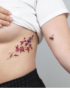 a close up of a person's stomach with flowers on it