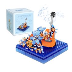 an orange and blue musical instrument with music notes coming out of the top, in front of a box