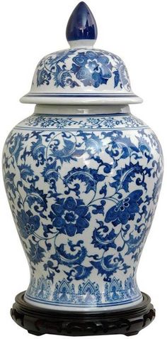 a blue and white vase with a lid