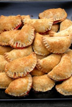 there are many small pastries on the black platter, ready to be eaten