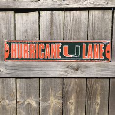 "University of Miami Sign University Miami Hurricanes Street Sign Miami Dorm Sign College Sign Dorm Room Decor Gifts for College Students -OFFICIALLY LICENSED University of Miami Hurricanes street sign - proudly MADE IN THE USA!  -Dimensions: approximately 24\" across x 5.5\" tall -This sign is made of .024\" embossed aluminum substrate, which will not rust (embossing is the process of creating raised areas or designs in the metal that create a three-dimensional effect) -Inks are lead free, and UV resistant so this sign is safe for indoor or outdoor use! -Light weight, single sided and all ready for hanging! For more great gifts, check out the rest of our shop!" Dorm In Out Door Signs, Miami Sign, Dorm Signs, Gifts For College Students, Room Decor Gifts, University Of Miami, Street Sign, Street Signs, Dorm Room Decor