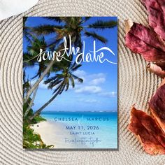 save the date card with palm trees and blue water in the background on a plate