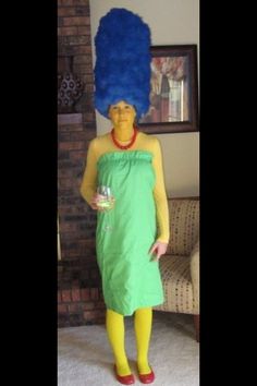 a person in a green dress and yellow tights with a blue wig on their head