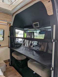 the interior of a camper van with two seats and a table in front of it