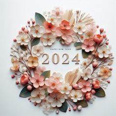 a wreath made out of paper flowers and leaves with the year 2014 written in it