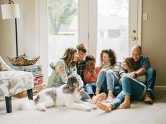 a group of people sitting on the floor with a dog