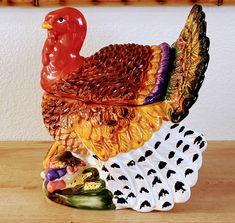 a ceramic turkey sitting on top of a wooden table