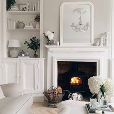 a living room filled with furniture and a fire place next to a tv mounted on a wall