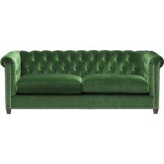 a green couch sitting on top of a white floor