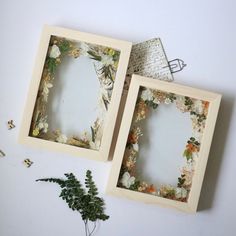 two frames with flowers are sitting next to each other