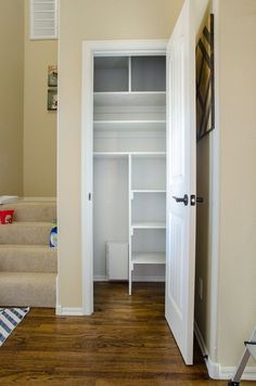 an empty closet with stairs leading up to it