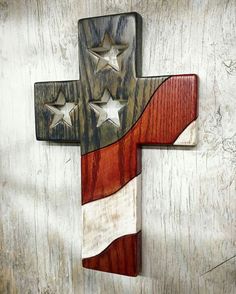 a wooden cross with stars on it and an american flag painted on the front side