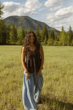 a woman standing in the middle of a field