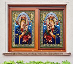 an image of the virgin mary and child jesus in stained glass on a window sill