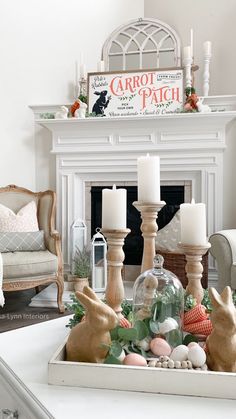 a living room decorated for easter with candles and bunny figurines on the coffee table