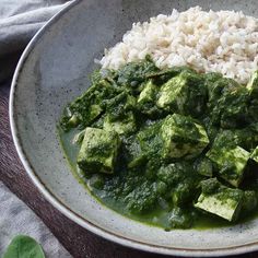 a white bowl filled with rice and green vegetables