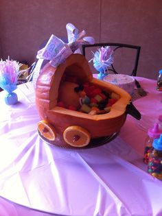 a pumpkin shaped like a baby carriage filled with candy