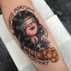 a woman's arm with a tattoo on it that says fortis fortuna