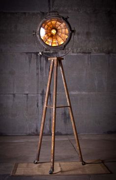 an old fashioned floor lamp with a wooden tripod