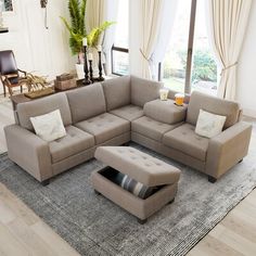 a living room with a sectional couch and ottoman