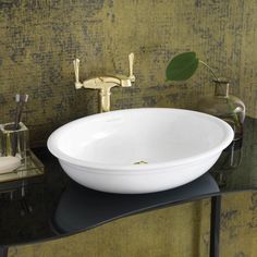 a white bowl sink sitting on top of a black counter